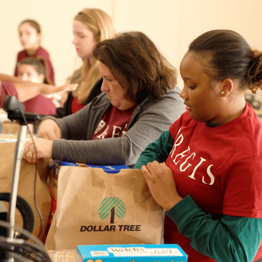 Regis volunteers sorting donations on Founders' Day