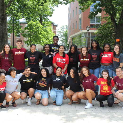 a group of smiling students in Regis gear on the Great Walk