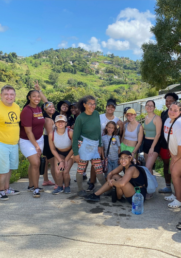 a group of students smiling at an outdoor service site in Puerto Rico