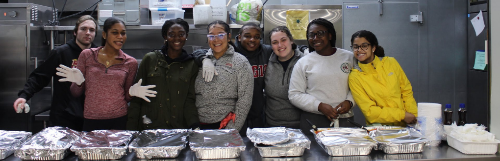 8 Regis students working at a soup kitchen