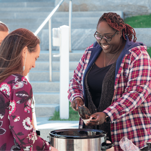 A competitor serving chili out of a slow cooker